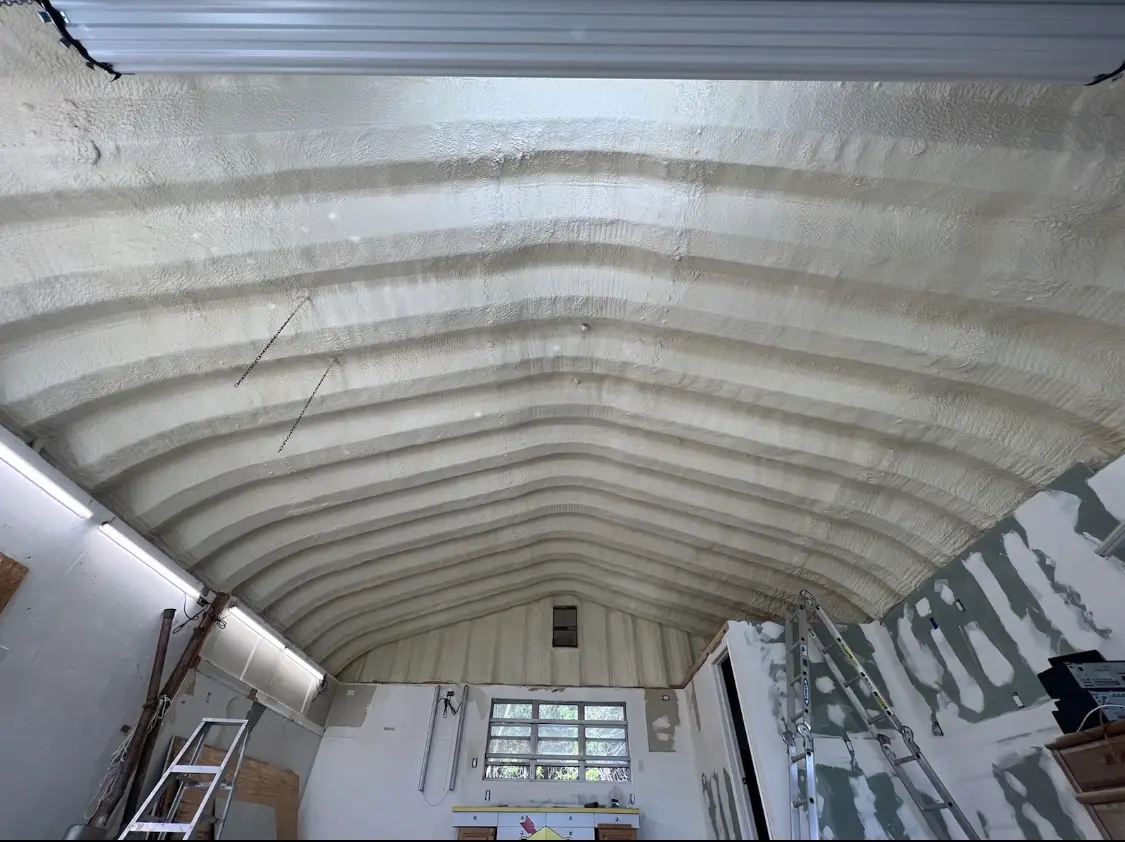 Spray polyurethane foam applied to the underside of a metal roof deck in Homer